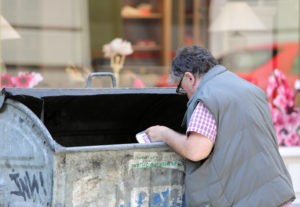 Man digging into a bin